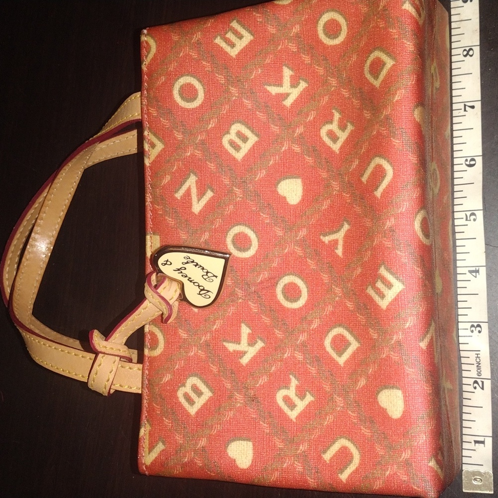 Pink and creme mini Dooney & Bourke, good condition. Does have one little stain.